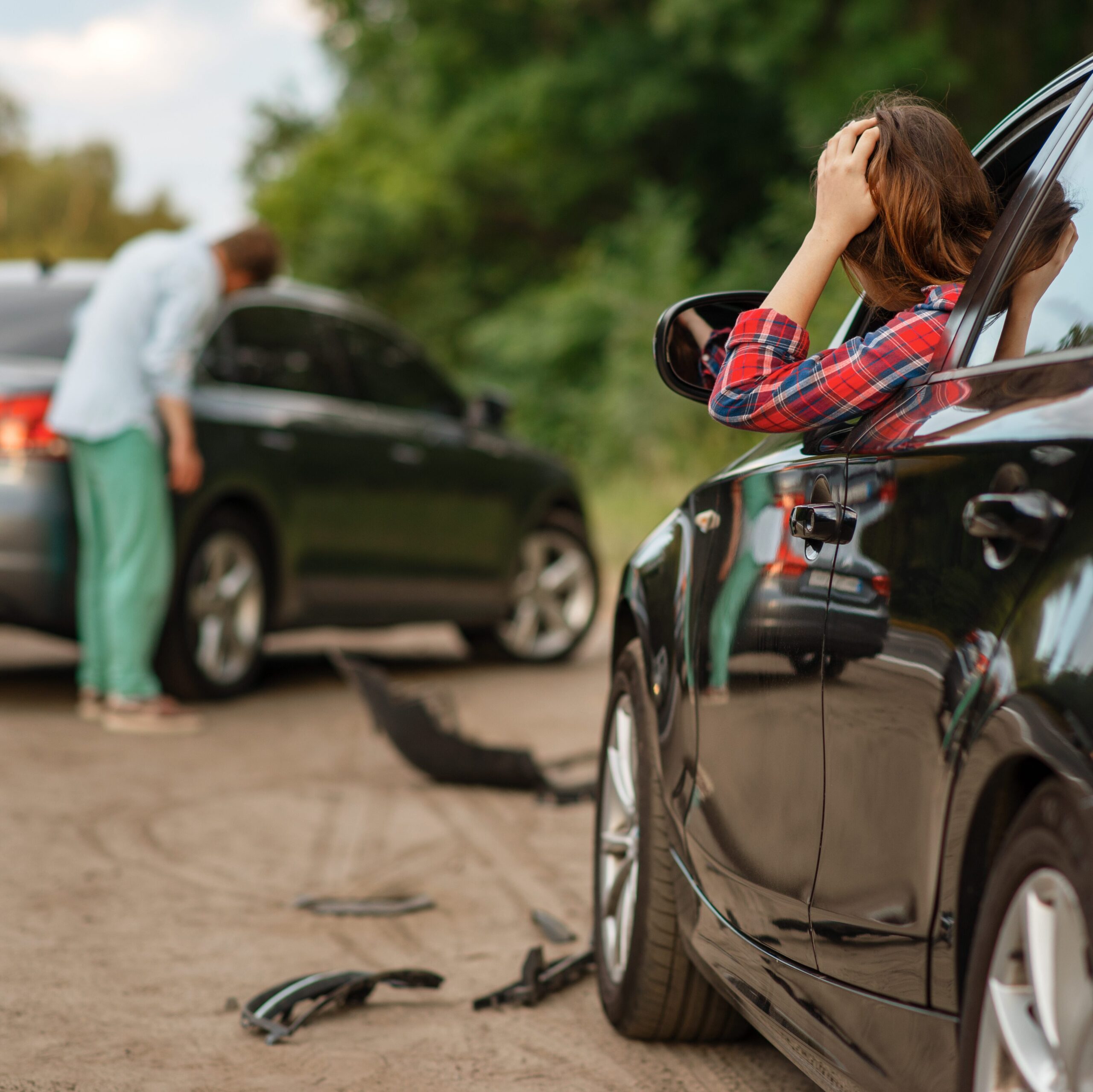 Male and female drivers after car accident on road. Automobile crash. Broken automobile or damaged vehicle, auto collision on highway