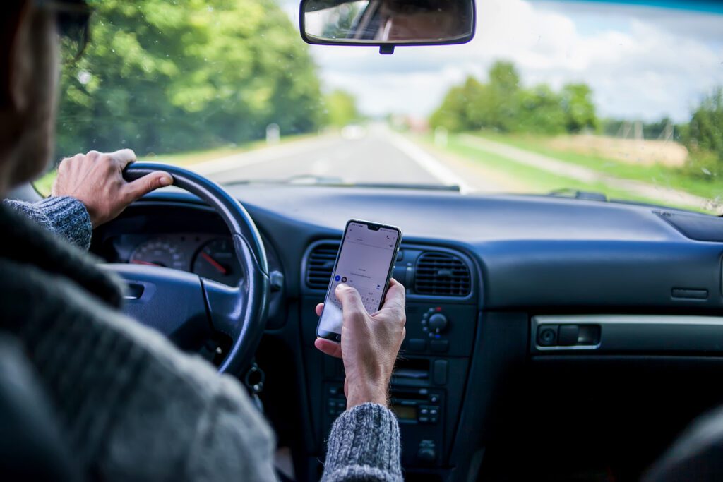 a person using their phone while driving