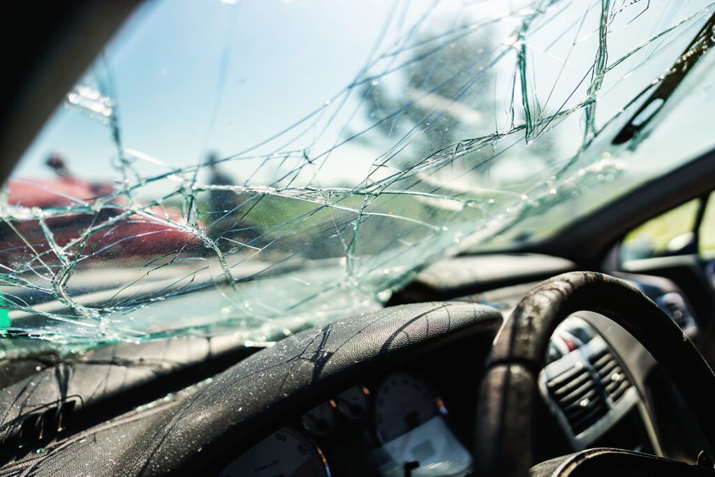 A cracked windshield as a result of a car accident.